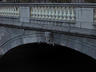 Dublin, Ireland - A worn face on a bridge over the...
