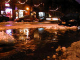 The melting snow makes a river of ninth street...